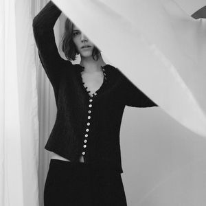 Irridescent buttons on crinkle fabric top